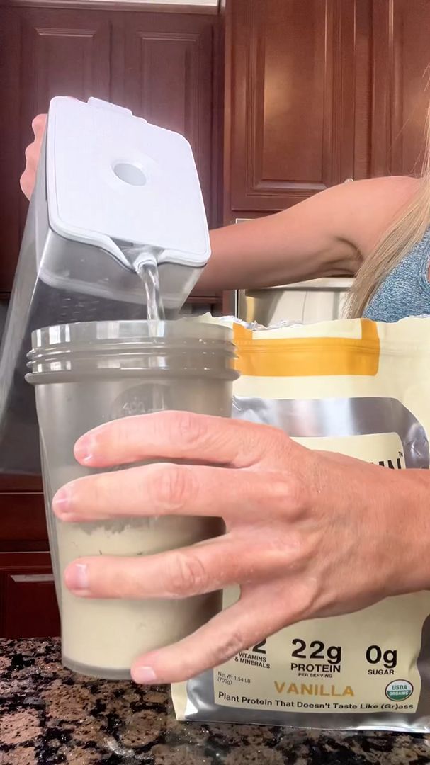Mixing a Cantein vanilla protein shake in a shaker cup
